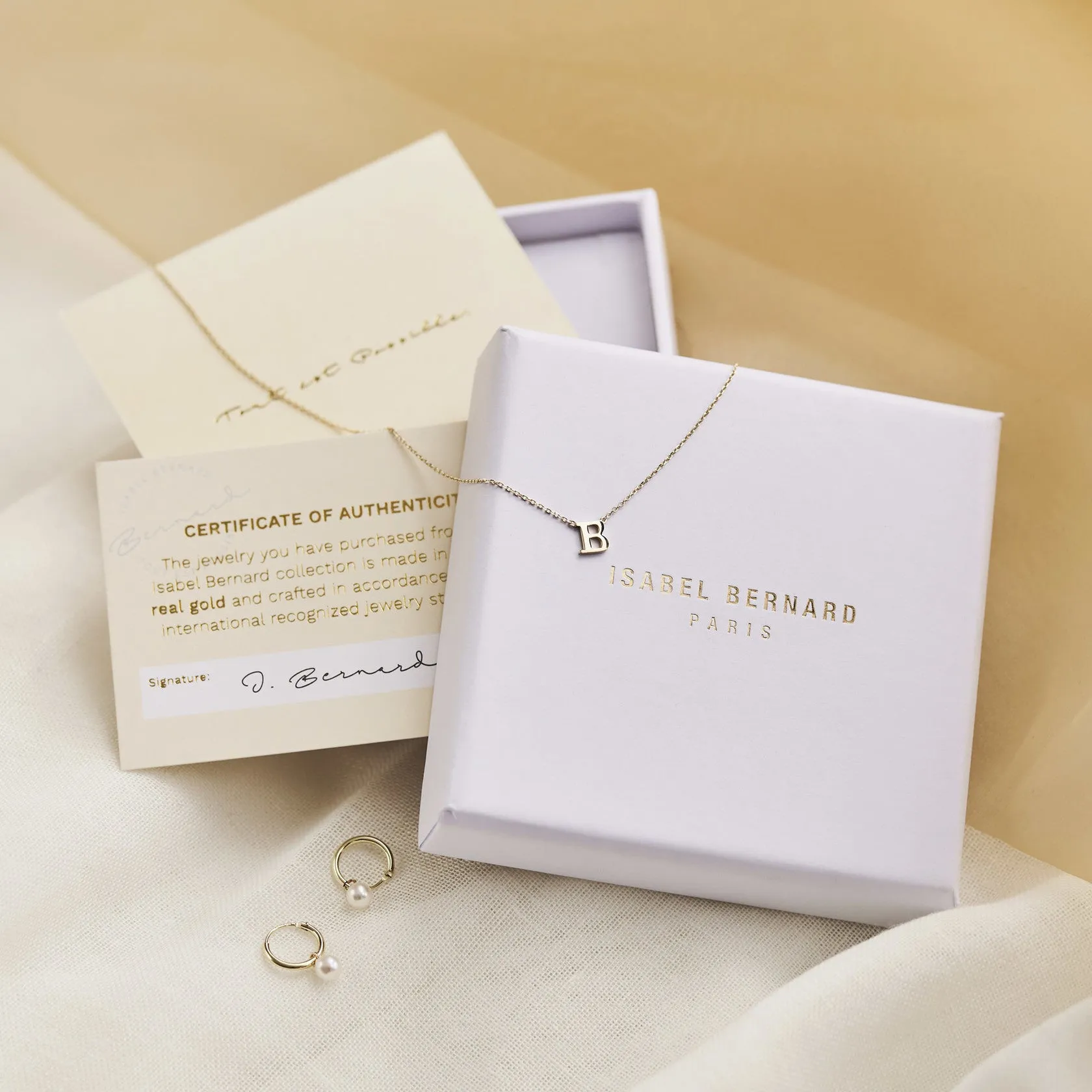 Cadeau d'Isabel 14 karat gold bracelet and ear studs set with pearls